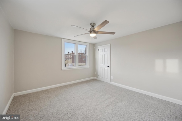 carpeted empty room with ceiling fan