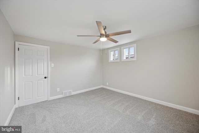 empty room featuring carpet flooring and ceiling fan