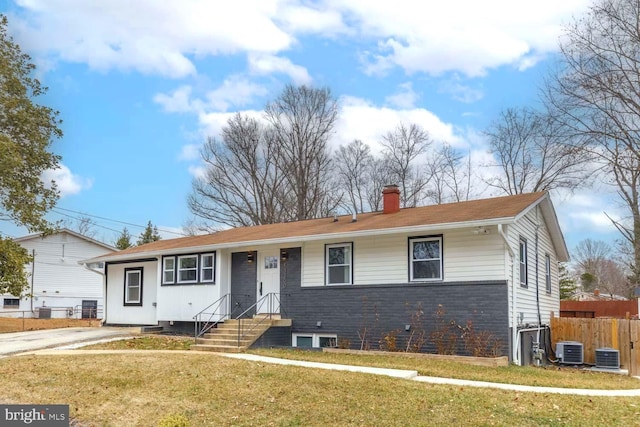 single story home with a front lawn, a chimney, cooling unit, and fence