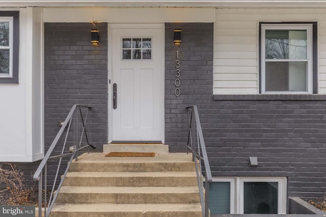 property entrance featuring brick siding