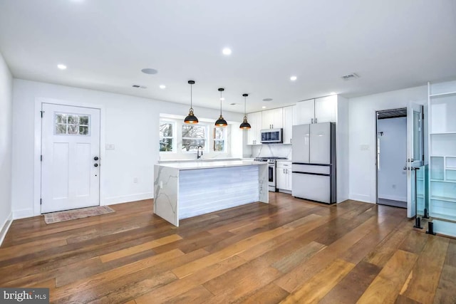 kitchen with visible vents, dark wood-type flooring, stainless steel appliances, white cabinetry, and recessed lighting