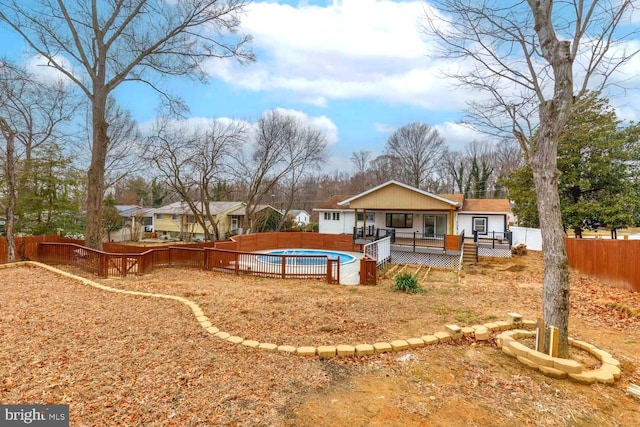 back of property with a pool side deck