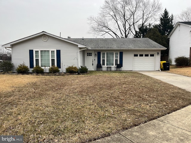 ranch-style home with a garage, driveway, and a front yard