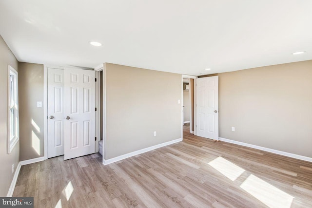 unfurnished bedroom with light wood-type flooring