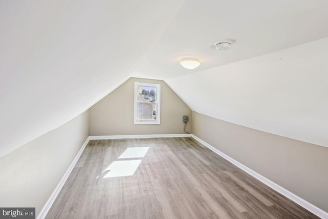 bonus room with light hardwood / wood-style floors and lofted ceiling