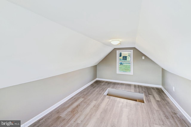 bonus room featuring light hardwood / wood-style floors and lofted ceiling