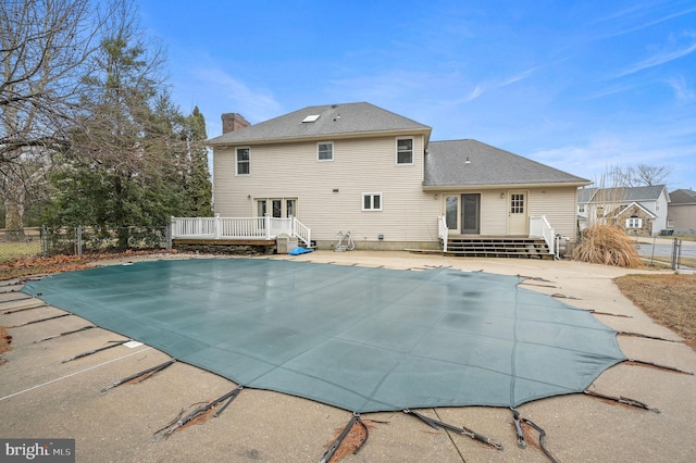 view of pool with a wooden deck and a patio