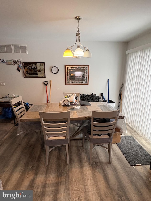 dining space with hardwood / wood-style flooring