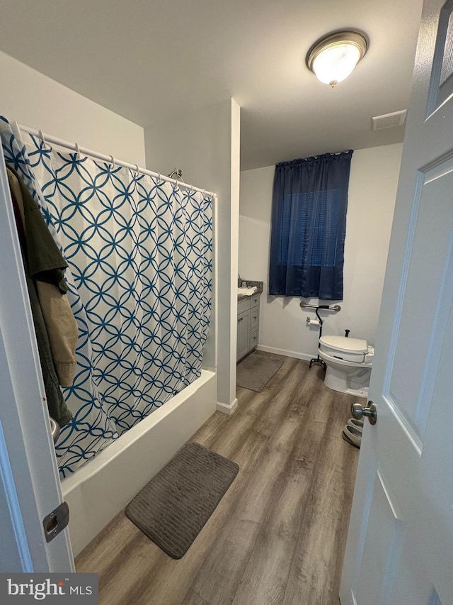 bathroom featuring hardwood / wood-style flooring, vanity, and toilet