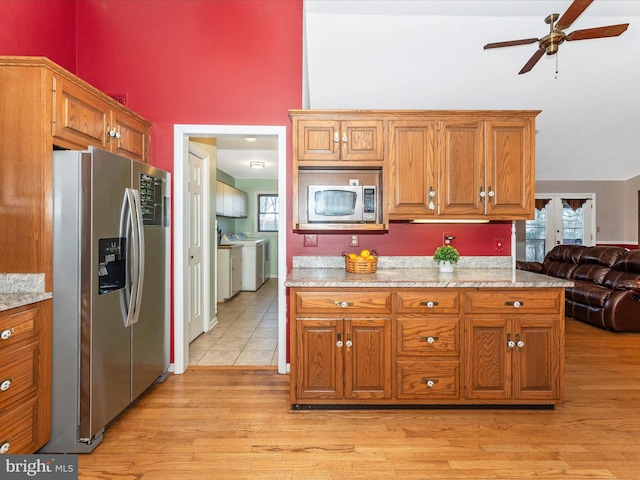 kitchen with light wood-type flooring, ceiling fan, appliances with stainless steel finishes, and plenty of natural light