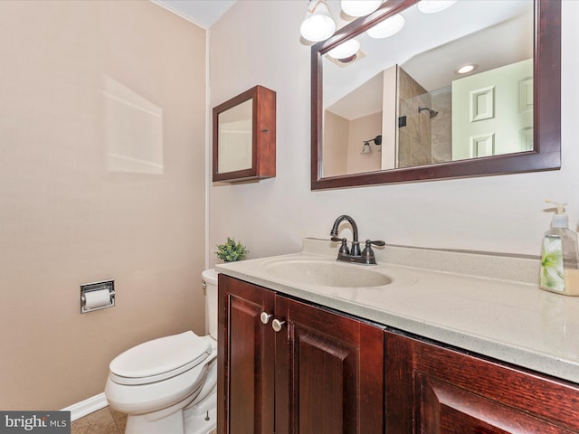 bathroom with toilet, vanity, tile patterned flooring, and a shower