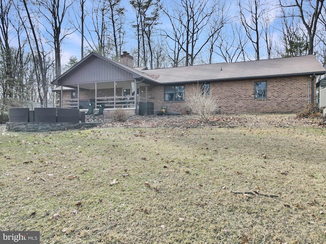 back of house with central AC unit, outdoor lounge area, and a lawn