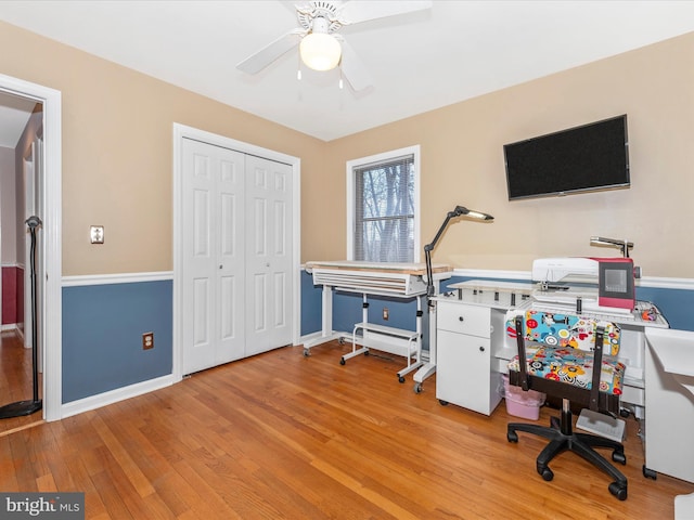 home office featuring light hardwood / wood-style flooring and ceiling fan