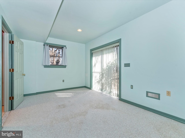 spare room featuring light colored carpet