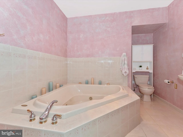 bathroom with tile patterned flooring, tile walls, toilet, and tiled tub