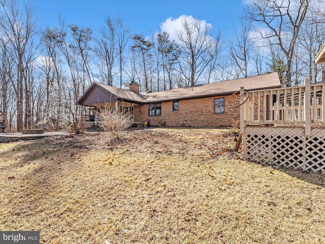 view of home's exterior featuring a lawn and a wooden deck