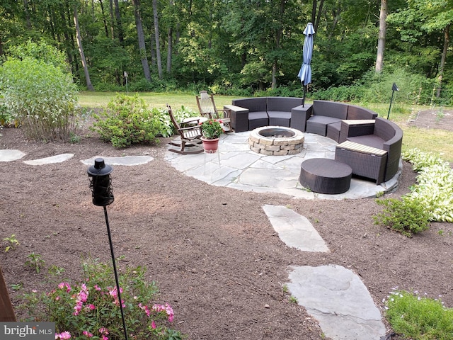 view of patio / terrace with an outdoor living space with a fire pit