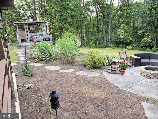 view of yard featuring an outdoor fire pit, a patio area, and a gazebo