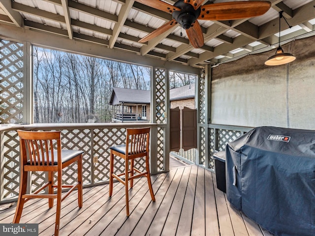 wooden deck featuring ceiling fan and a grill