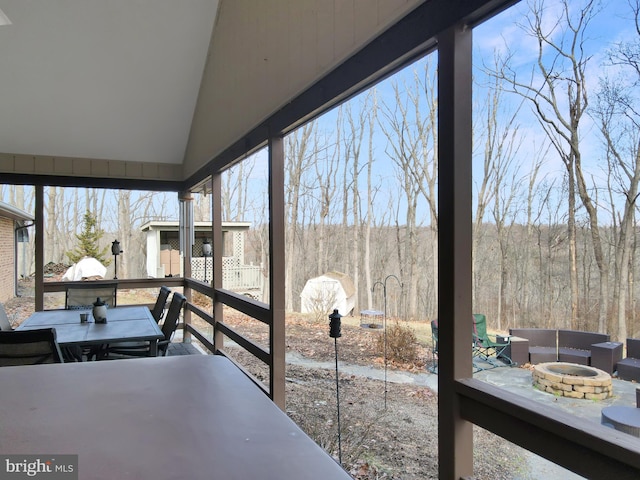 sunroom featuring vaulted ceiling