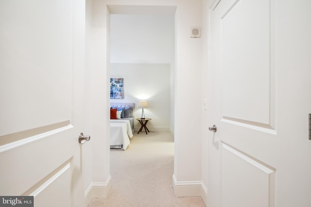 hallway with light colored carpet