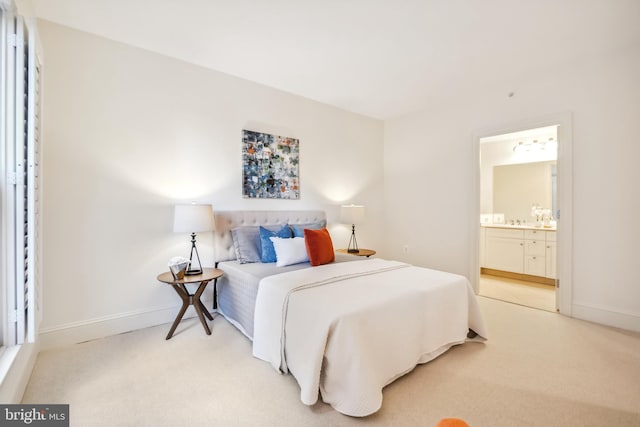 bedroom featuring carpet floors and ensuite bath