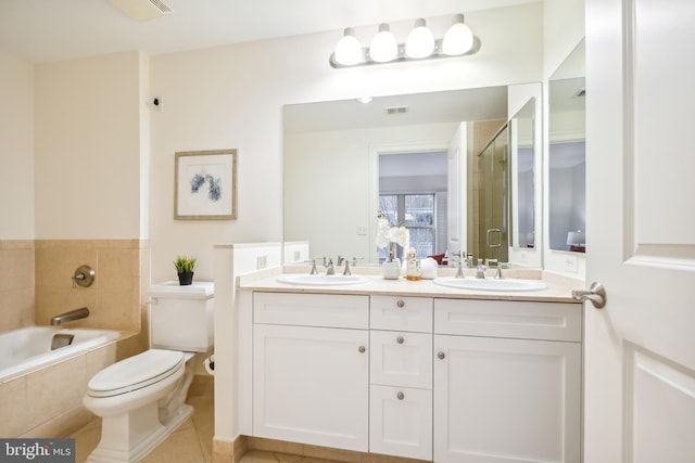 full bathroom featuring shower with separate bathtub, toilet, tile patterned floors, and vanity