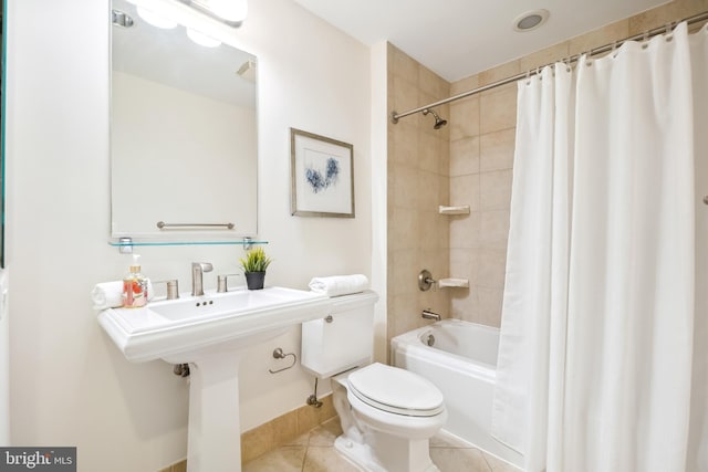 bathroom featuring shower / bath combination with curtain, tile patterned flooring, and toilet