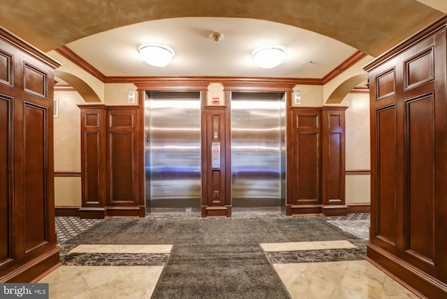 interior space with elevator and ornamental molding