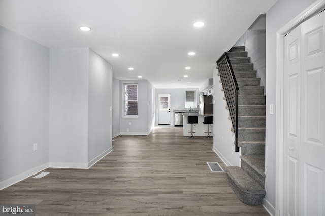 entrance foyer with sink and hardwood / wood-style floors