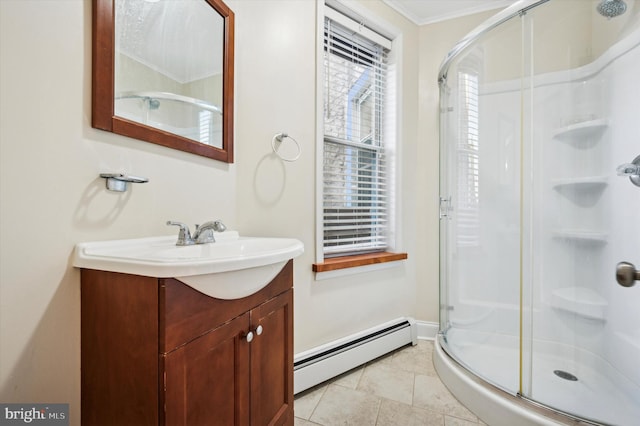 bathroom featuring a baseboard heating unit, an enclosed shower, vanity, ornamental molding, and tile patterned floors