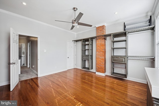 interior space with ornamental molding, wood-type flooring, and ceiling fan