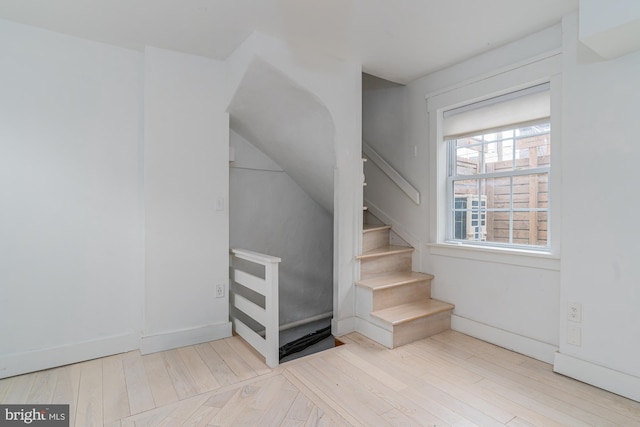 stairs featuring hardwood / wood-style floors