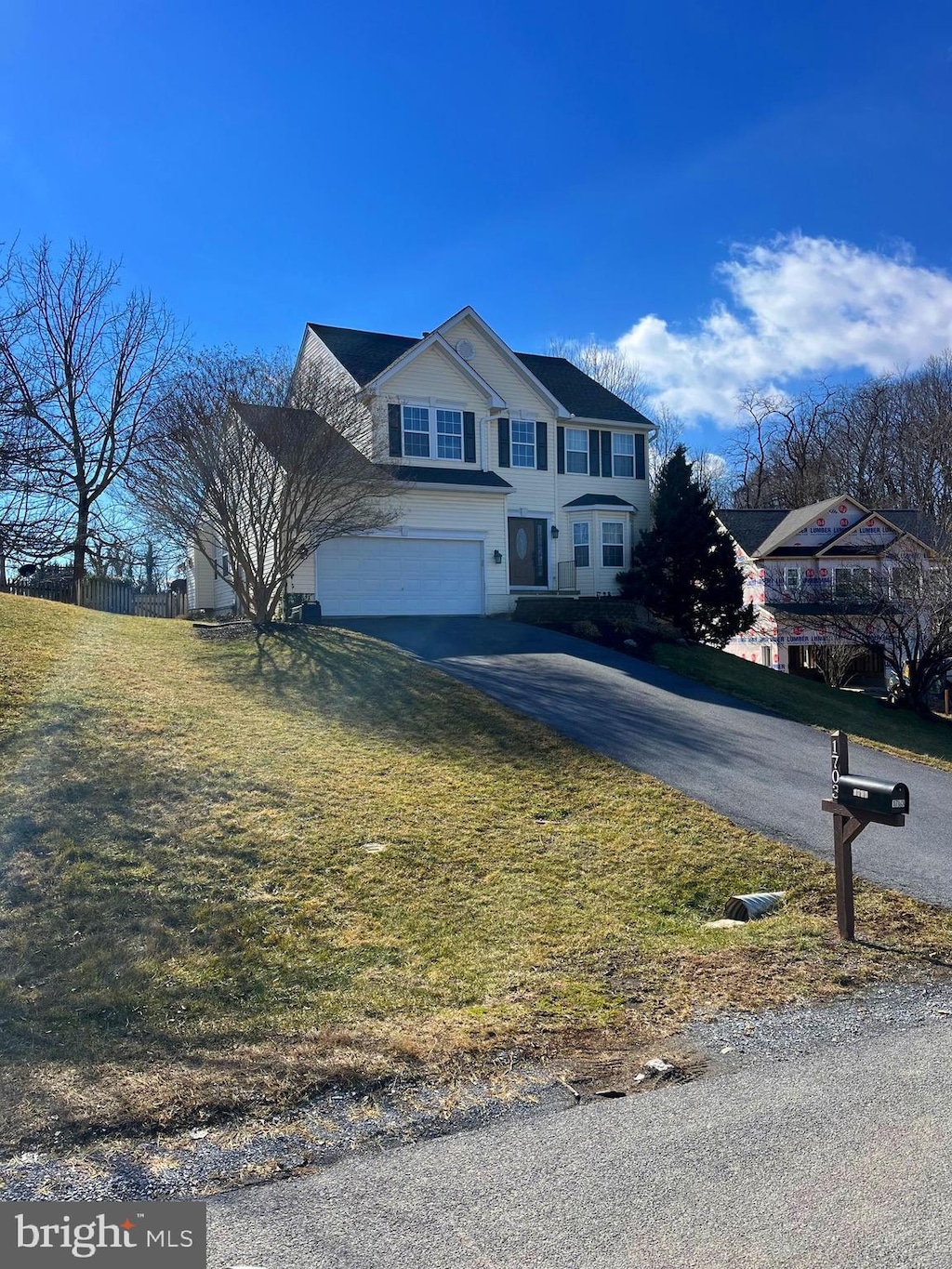 traditional-style home with driveway and an attached garage