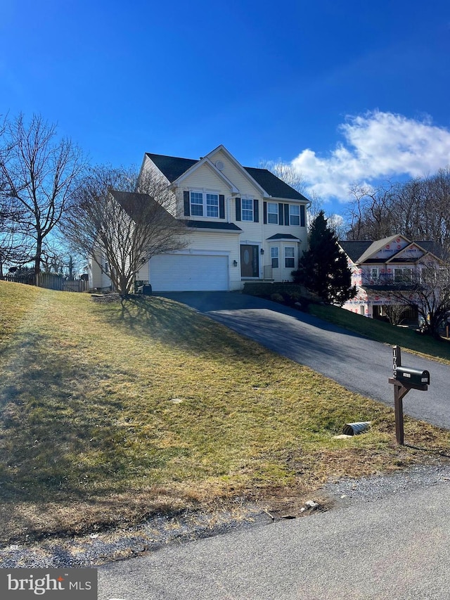 traditional-style home with driveway and an attached garage