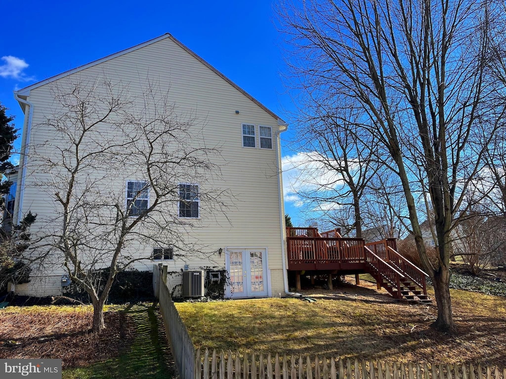 exterior space featuring a deck, central AC unit, and stairs