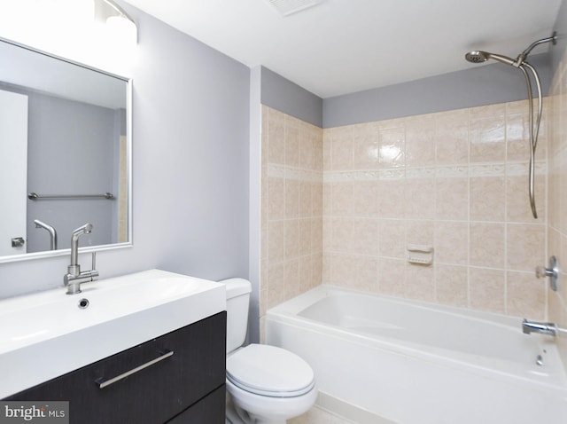 full bathroom with vanity, tiled shower / bath, and toilet