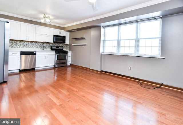 kitchen featuring stainless steel appliances, white cabinetry, ornamental molding, and ceiling fan