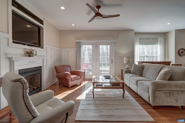 living room with wood-type flooring and ceiling fan