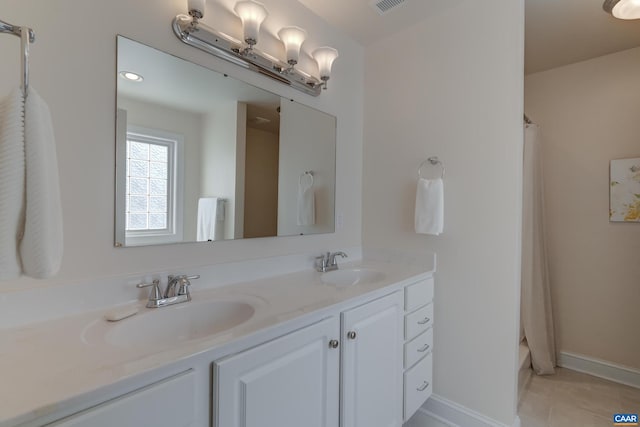 bathroom with walk in shower, tile patterned floors, and vanity