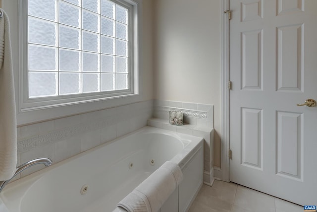 bathroom with tile patterned flooring and a bathtub