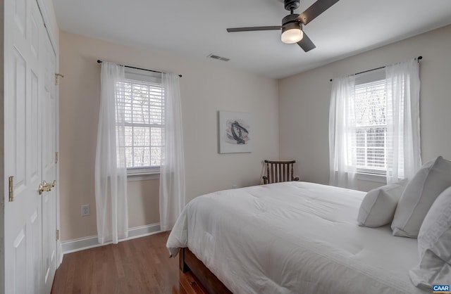 bedroom with hardwood / wood-style floors and ceiling fan