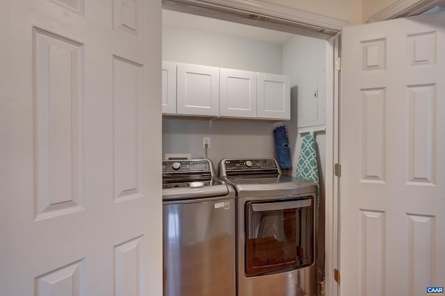 laundry room featuring cabinets and washer and clothes dryer