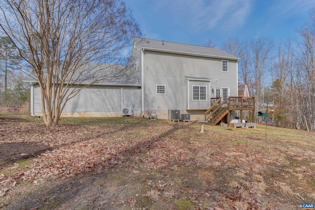 back of house featuring central air condition unit and a deck