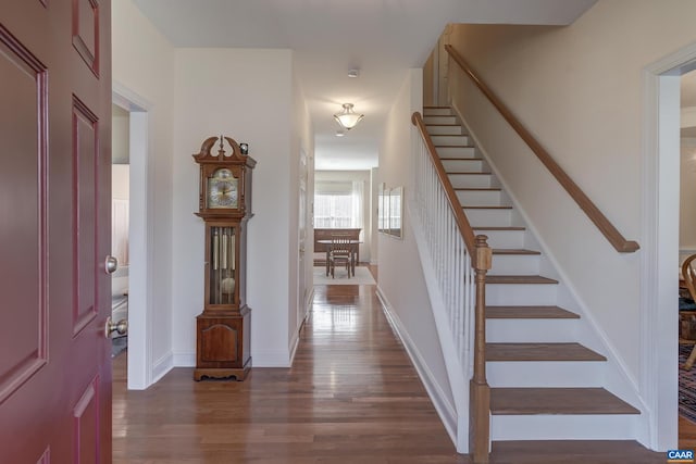 entryway with dark hardwood / wood-style flooring