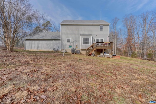 rear view of property featuring a yard and a deck