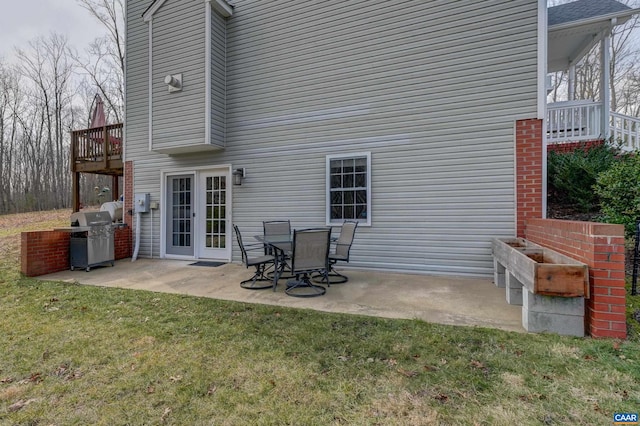 back of house with a lawn and a patio area