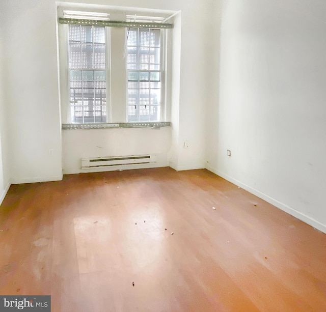 2130 N 19th St, Philadelphia, PA 19121 - unfurnished room with a baseboard radiator, wood finished floors, and baseboards