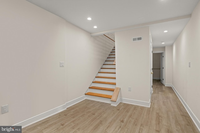 staircase with hardwood / wood-style floors