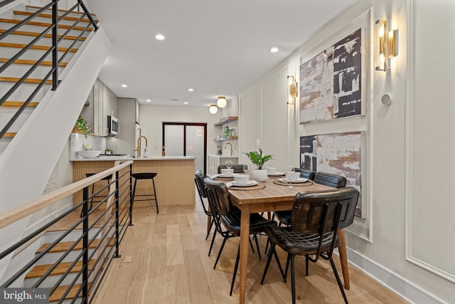 dining space with light wood-type flooring